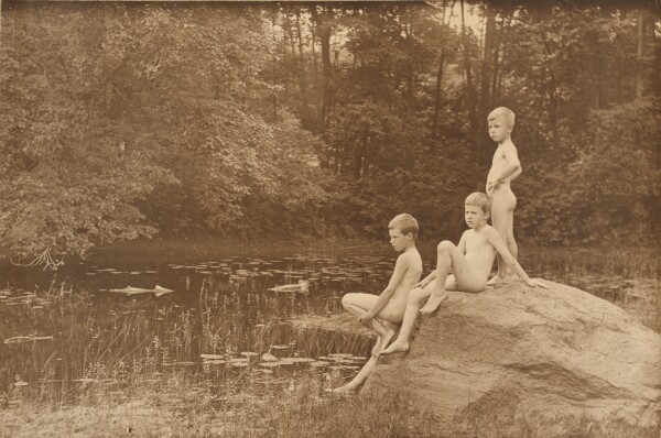 Unknown, [Three nude boys on rock by pond]