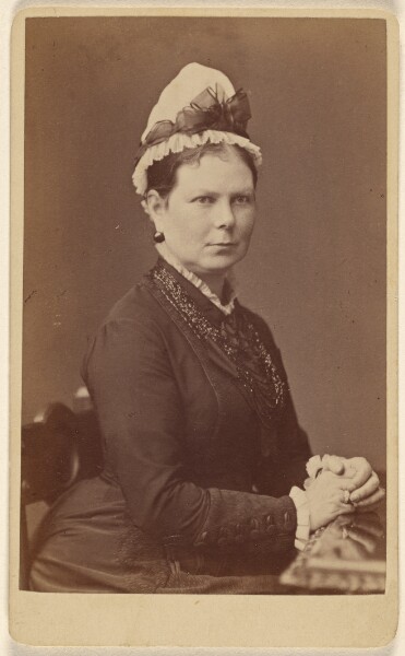 George Washington Wilson, [Unidentified woman wearing a bonnet with a bow, seated with hands together]