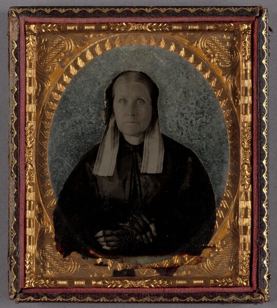 Unknown, [Portrait of a Seated Middle-aged Woman in Bonnet with Hands Crossed]