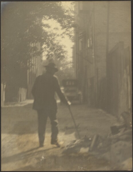 Louis Fleckenstein, [Man Walking Down a Street]