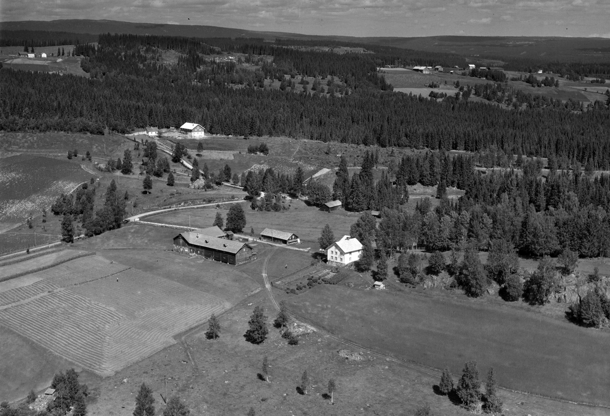 Widerøes Flyveselskap A/S, Flyfoto av Busmundrud gard midt i bilde, man ser Skredderstuen i overkant av bildet. Åsmarka, Ringsaker.