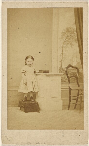 Unknown, [Unidentified little girl, standing on covered box]