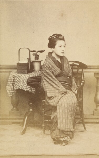 Felice Beato, [Woman sitting by table]
