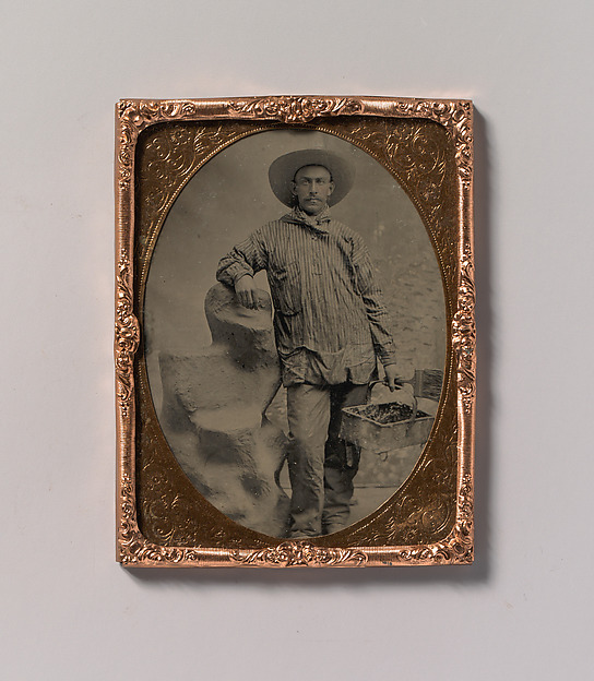 Unknown, [Workman Holding Brush and Rectangular Tray, Arm Resting on Fake Rock]