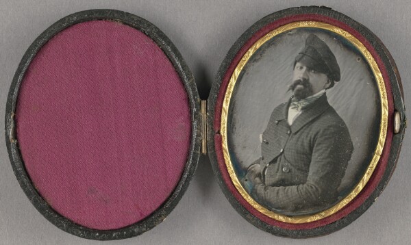 Unknown, [Portrait of a man with a busy moustache and goatee, wearing an angled cap]