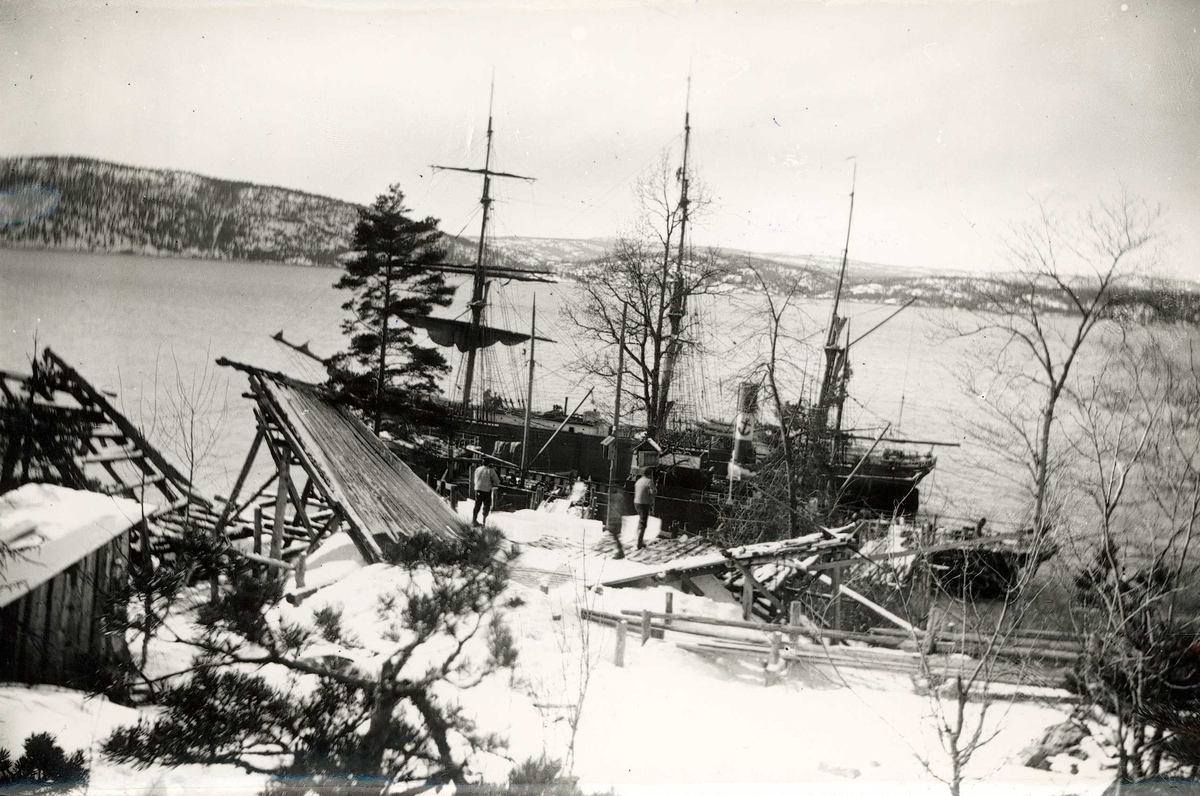 Axel Quinsgaard Wiborg, Islasting, Sønderstøen, Nesodden, Akershus, 1907. Arbeidere med isblokker på toppen av reisverk i tre med renne for lasting av isblokker fra land til seil - og dampskip, D/S "Ringfond", nedenfor. Fra serie tatt v iseksportør Axel Quinsgaard Wiborg (d. 1944).
