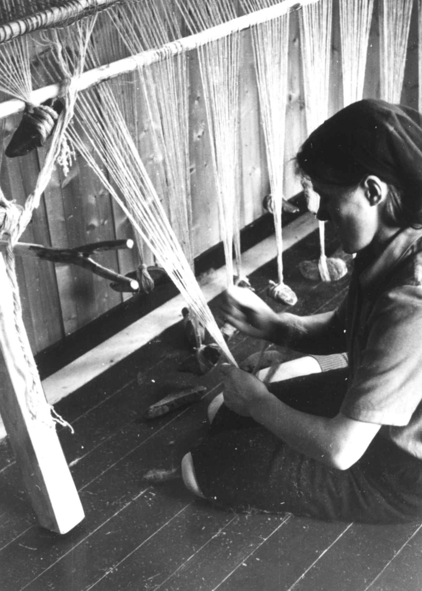Anna Grostøl, Greneveving. En kvinne fester steinlodd til renningen. Lyngen, Troms 1947.