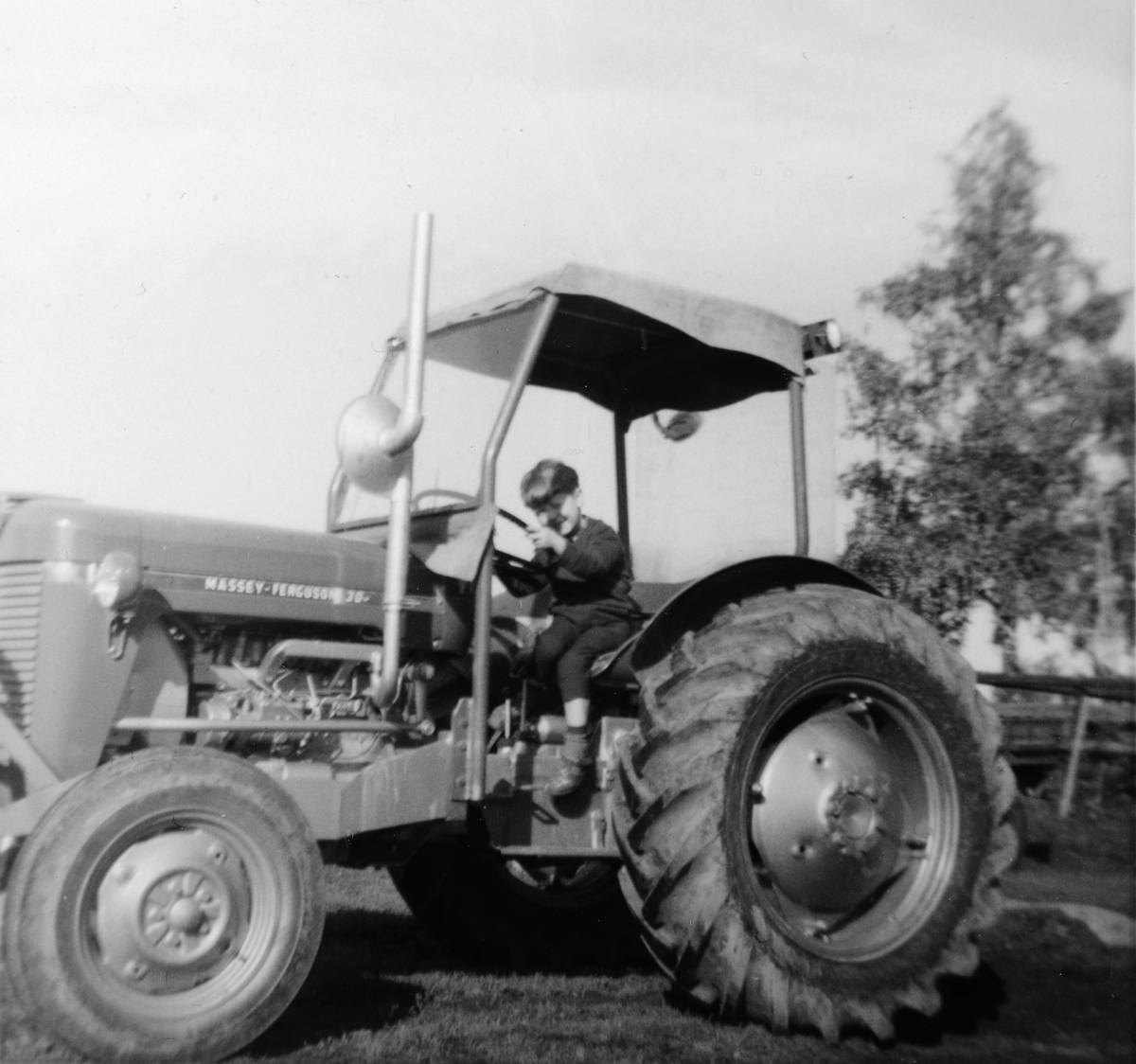 Ukjent, Jølstad, gnr. 360. Traktor Massey Ferguson 30. Helge Roar Foss f. 1960 sitter på traktoren. Dette var den andre traktoren de hadde på Jølstad.