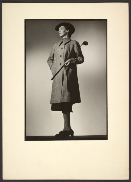 Günther Krampf, [Woman modeling coat with golf club]