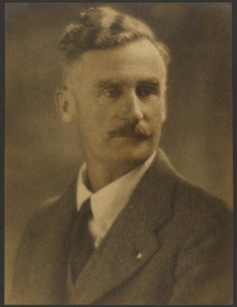 Louis Fleckenstein, [Portrait of a Man with White Lapel Pin]
