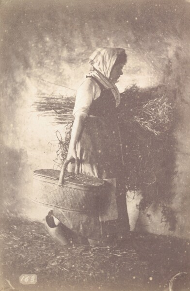 Unknown, [Woman carrying a basket and armful of brush]