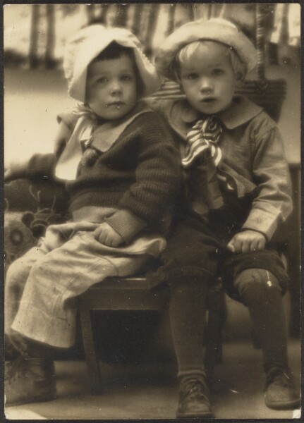Louis Fleckenstein, [Two Children Sharing Chair]