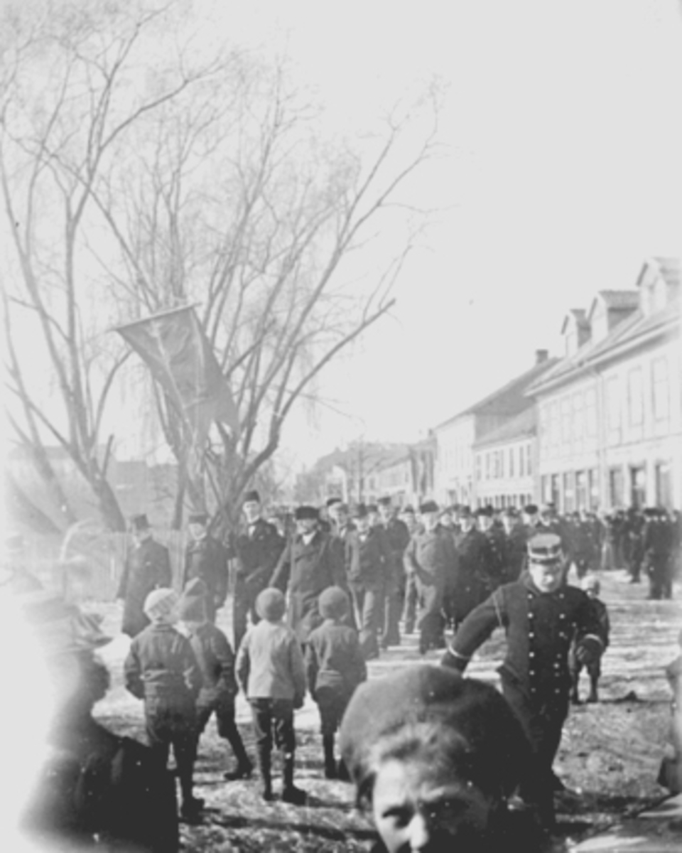 Anno Domkirkeodden, Opptog, Strandgata i Hamar, Byjubileet 1899, byens 50-årsjubileum, folketog i Strandgata. Toget gikk fra Stortorge, t via Strandgata, til Østre Torg der ordfører Hord holdt tale.
