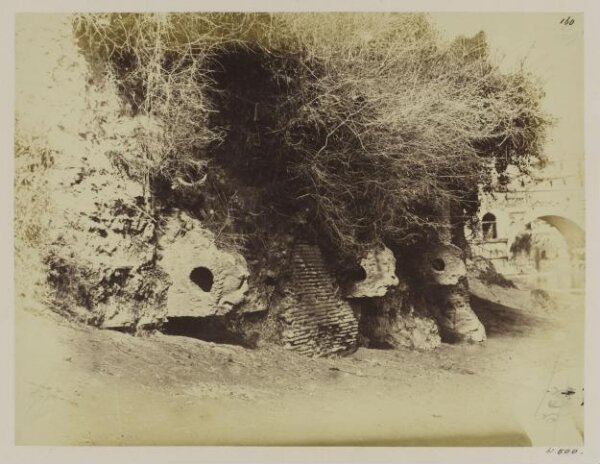 Parker, John Henry, The Tiber - The Port of Rome, upper part called also Porta Leoni. Corbels carved into Lions' heads of Etruscan character, B.C. 180 (?) (Livii Hist, xl. 51), to carry a wooden pole for fixing a large iron chain or rope across, or for mooring vessels at the top of the harbour.