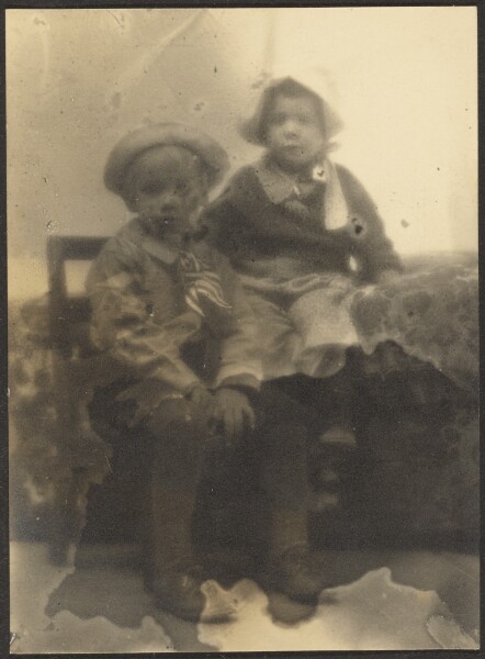 Louis Fleckenstein, [Two Children Sharing Chair]