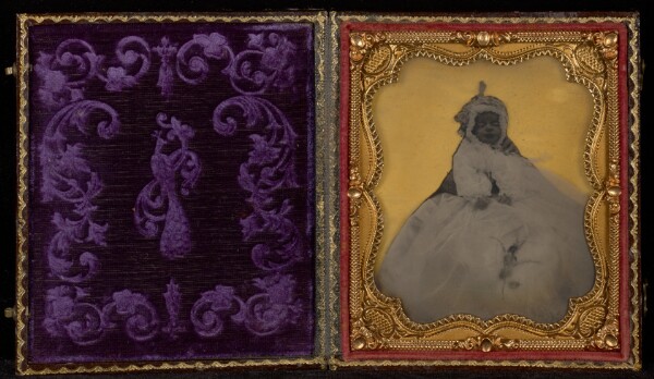 Unknown, [Portrait of an Infant in White Bonnet and Dress with Hand of Parent Visible]