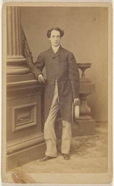 Unknown, [Unidentified man wearing gloves, holding a straw hat in his left hand, standing]