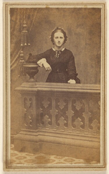Unknown, [Unidentified woman standing, resting elbow on a vase]
