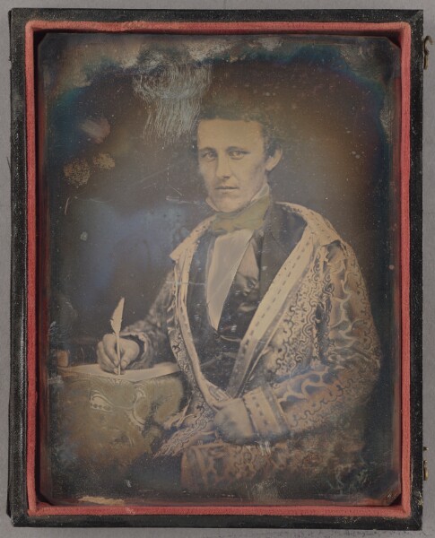 Unknown, [Portrait of an Unidentified man in smoking jacket seated holding a feather-quill pen]
