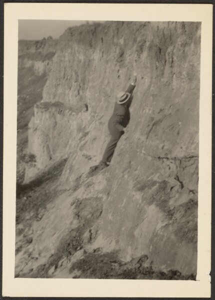 Louis Fleckenstein, [Man Wearing Suit Scaling Rocks]