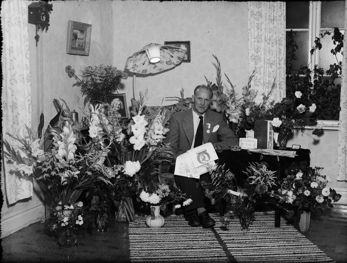 Skötsner-Edhlund, Man omgiven av blommor i bostadsmiljö, Östhammar, Uppland