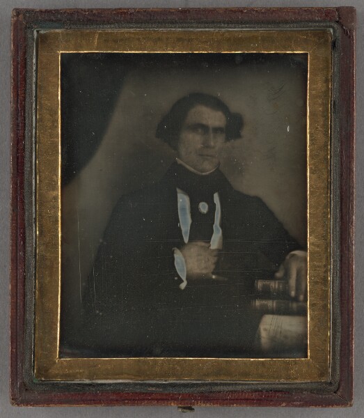 Unknown, [Portrait of a man posed with books]