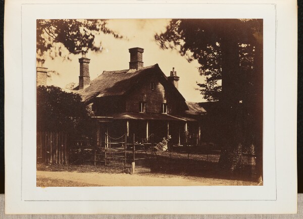 Unknown, [View of a Man and a Woman Sitting on a Porch]