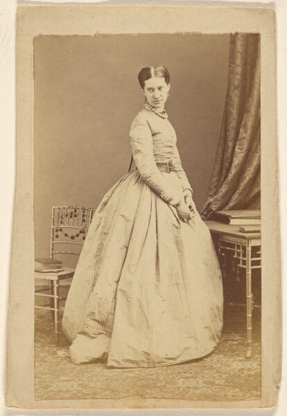 Unknown, [Unidentified woman wearing a long dress, standing]