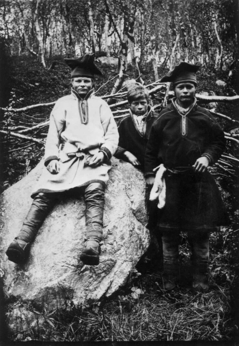 Ellisif Rannveig Wessel, Tre gutter ved en stein. Sandnes, Sør-Varanger, Finnmark, før 1900. Johan Petter Hallonen t. v.