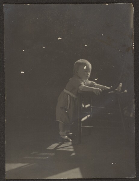 Louis Fleckenstein, [Young Child Leaning on Chair]