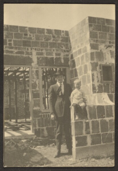 Louis Fleckenstein, [Man with Standing with Child in House Under Construction]