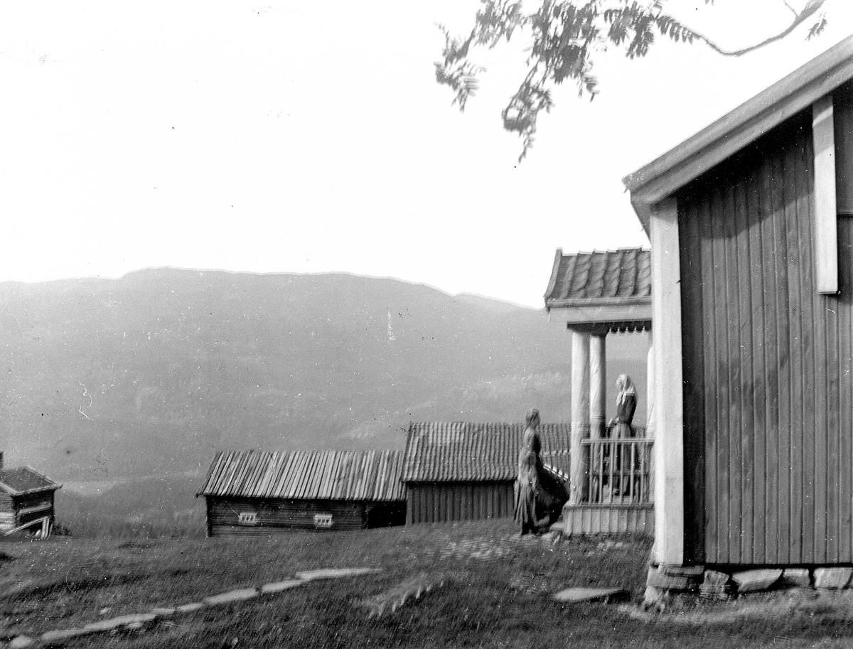 Juliane Fredrikke Langberg, Fra Eggedal, Sigdal, på besøk hos Th. Kittelsen. Fra gårdstun med 2 kvinner i inngangsparti til våningshus. Muligens huset hvor Harriet Backer malte bildet "Lekseoverhøring". Fra malerinne Juliane Fredrikke Langbergs samling, tatt 1895-1910 med motivkrets slekt og venner samt steder tilknyttet samv…