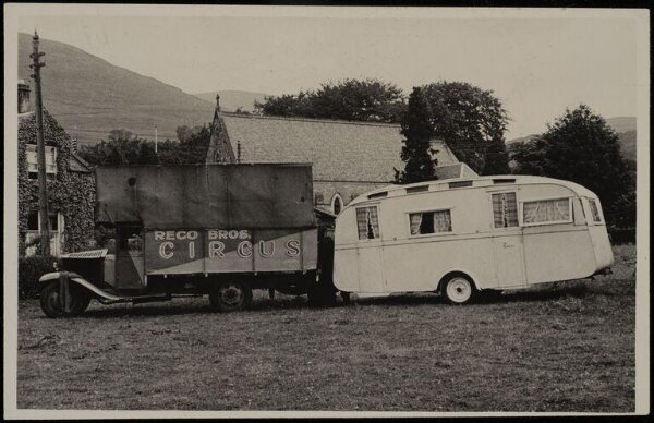 Hinde, John Wilfrid, view of a circus truck and caravan