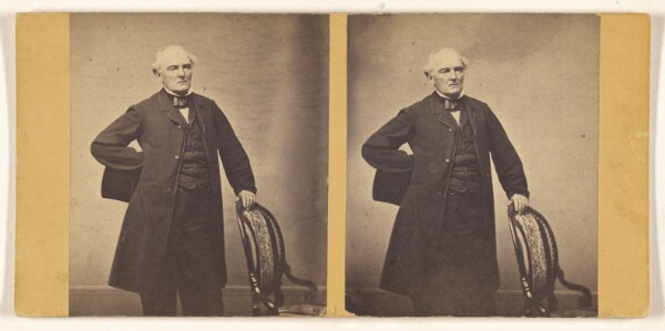 Unknown, [Unidentified man standing, holding chair back and top hat]
