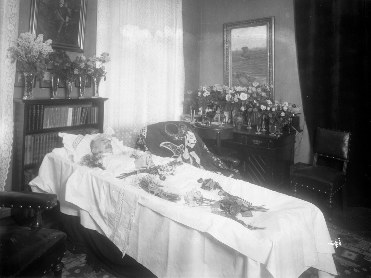 Gustav Borgen, Post mortem-fotografi. Død mann i pyntet kiste, ukjent sted.
