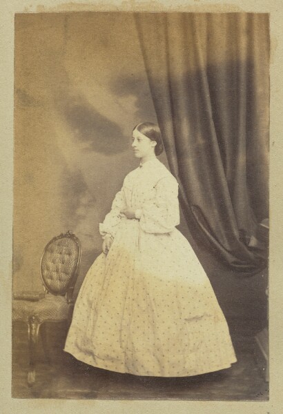 Unknown, [Portrait of girl in long polka-dotted dress]