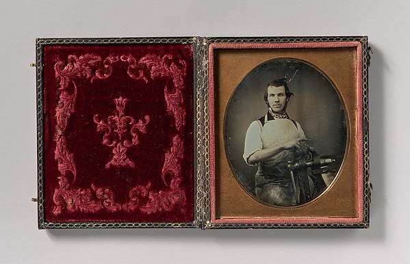Unknown, [Metalworker in Apron Working with a Vise]
