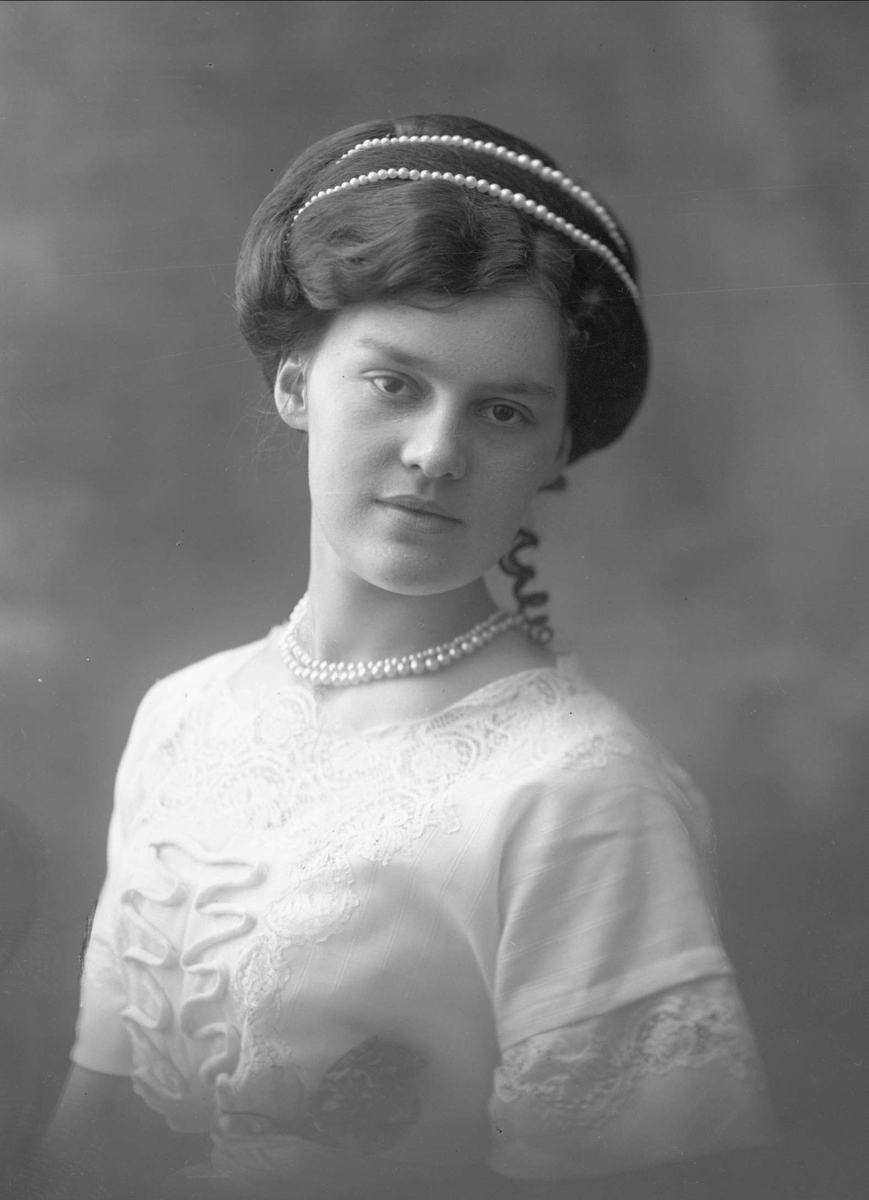 Gustav Borgen, Portrett, kvinne med lys kjole og perlebånd i håret og om halsen. Frøken Constance Johansen.