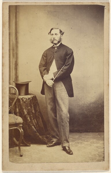Unknown, [Man holding a cane under his arm]