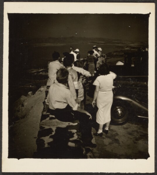 Louis Fleckenstein, [Group Seated on Stone Wall over Coast]