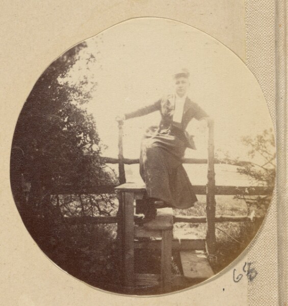 Unknown, [Woman in hat posed on a stile]