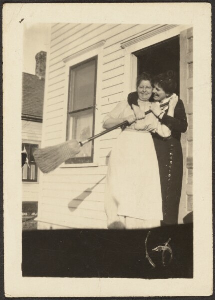 Louis Fleckenstein, [Mother and Daughter Playful with Broom in Doorway]
