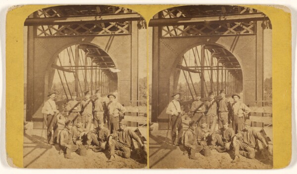 Unknown, [Men posing at entrance to bridge]