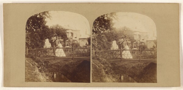 Unknown, [Woman standing on footbridge over stream]