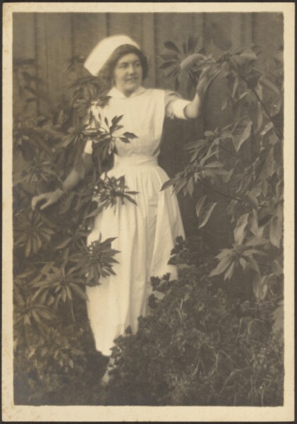 Louis Fleckenstein, [Woman Dressed as Nurse in Garden]