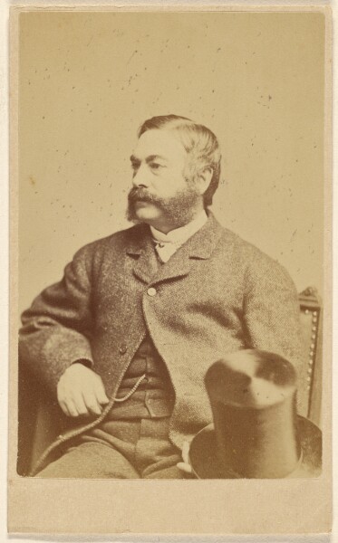 J. A. Whipple, [Bearded man with top hat on knee, seated]