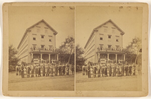 Unknown, [Exterior view of E.M. Clark & Co. with numerous people on and surrounding the building]