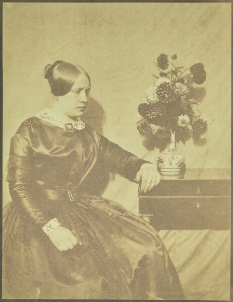 Hippolyte Bayard, [Portrait of a Woman Seated beside a Table with Flowers]