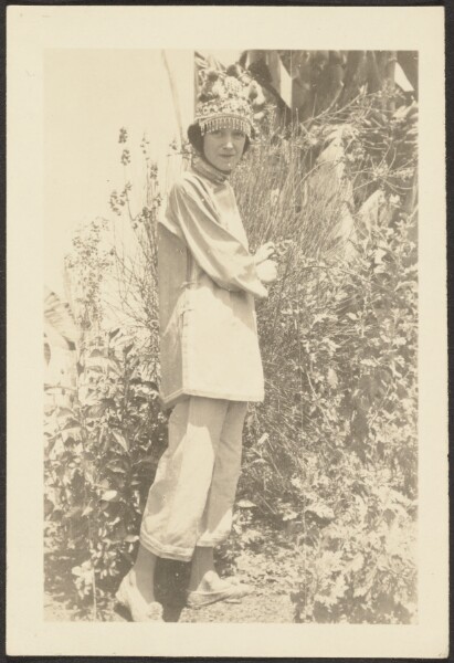 Louis Fleckenstein, [Woman in Costume Standing in Garden]