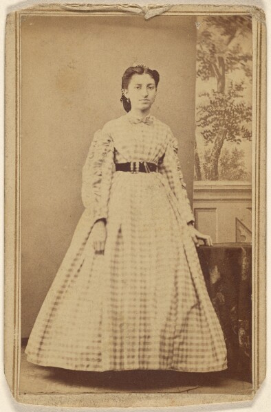 Unknown, [Unidentified woman in checkered dress, standing]